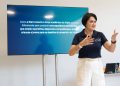 Lilian Damasceno apresenta proposta educacional em sala, diante de uma tela