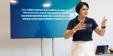 Lilian Damasceno apresenta proposta educacional em sala, diante de uma tela